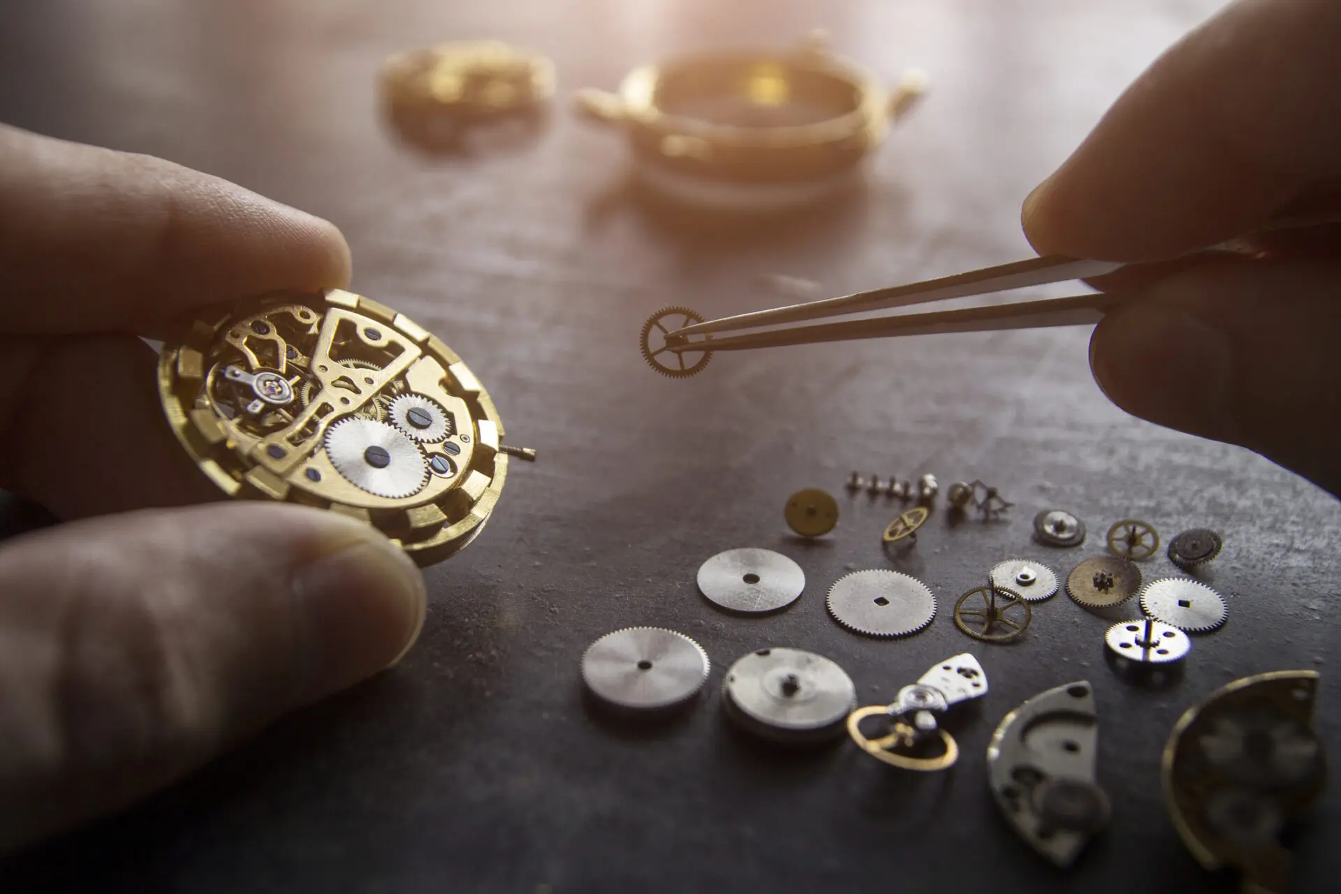 A person working on some parts of a watch